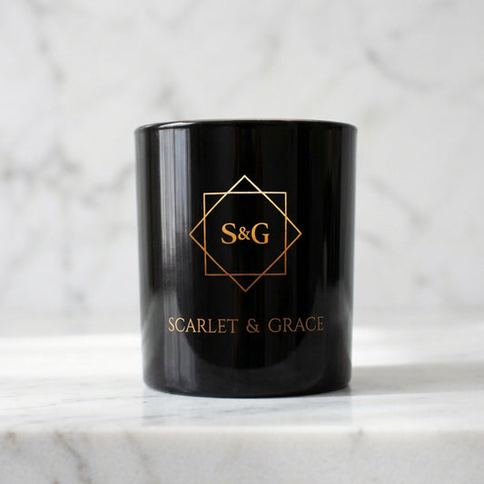 A black raspberry and vanilla scented candle with the brand logo 'Scarlet & Grace' on the side.